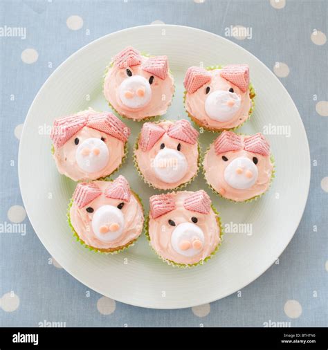 A Plate Of Pink Pig Iced Homemade Buns For A Childs Birthday Party