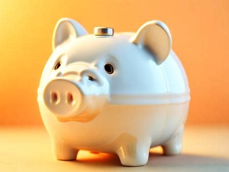 A White Piggy Bank Sitting On Top Of A Table Image Design Id