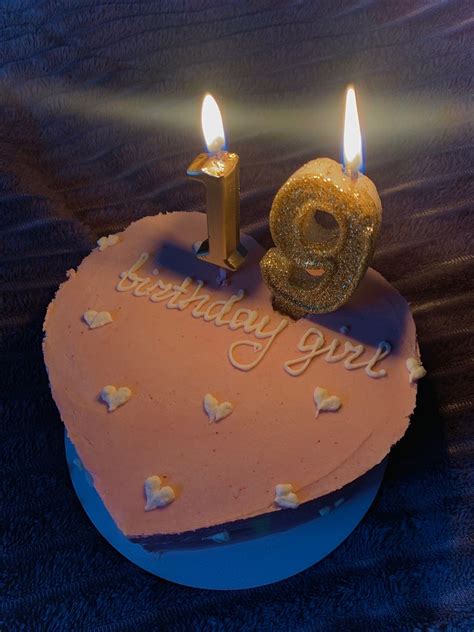 A Birthday Cake With Two Lit Candles On It And The Number Nine In The