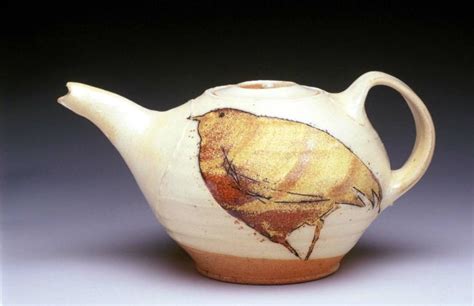 A Tea Pot With A Bird Painted On It