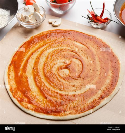 Pizza Base With Tomato Sauce Process Of Preparing Stock Photo Alamy