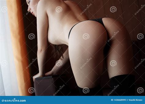 Sensual Nude Woman In Lingerie And Stockings On Settee In Room Stock Image Image Of Flat