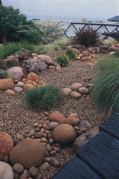 Grasses and rocks | Rock garden landscaping, Backyard landscaping, Rock ...