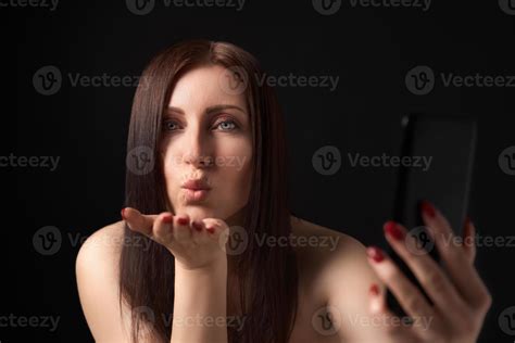 Woman Blowing Lips Sending Air Kisses Over Palm Taking Selfie To