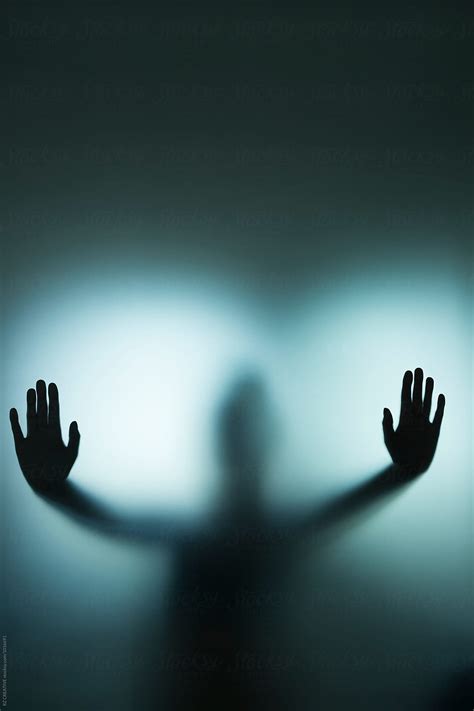 Backlit Figure With Hands Pressed Against Frosted Glass By Stocksy Contributor Rzcreative