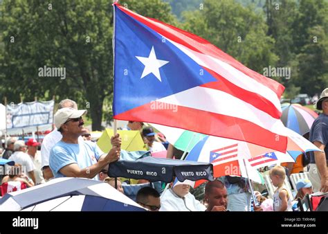 A man flies a Puerto Rican flag in honor of National Baseball Hall of ...