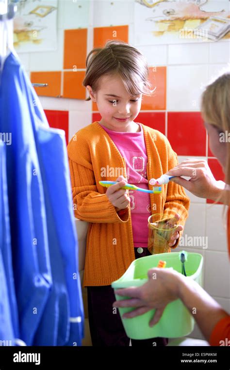 6 year old girl brushing her teeth at school Stock Photo - Alamy