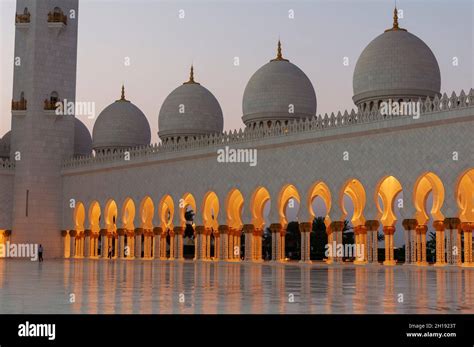 Domes And Lighted Archways At The Sheikh Zayed Grand Mosque At Dusk