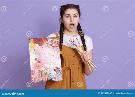 Close Up Shot Of Female Artist Holding Color Palette And Paint Brush In