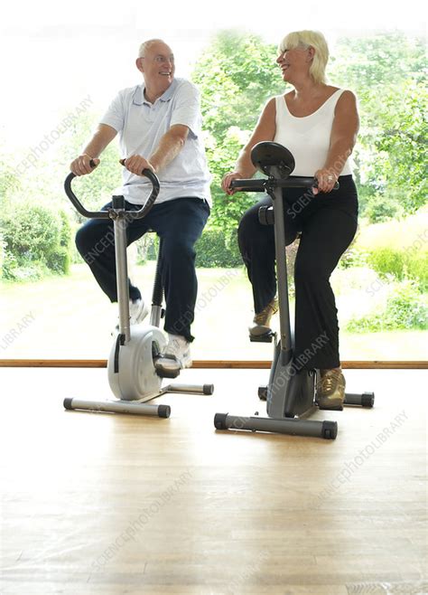 Older Couple Riding Stationery Bikes Stock Image F004 1103