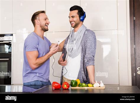 Smiling Gay Couple Listening To Music Stock Photo Alamy