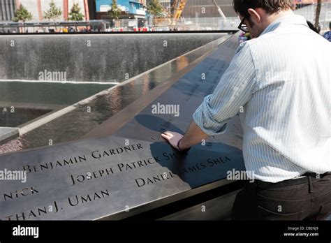 A visitor reads the names at the National September 11 Memorial in New ...