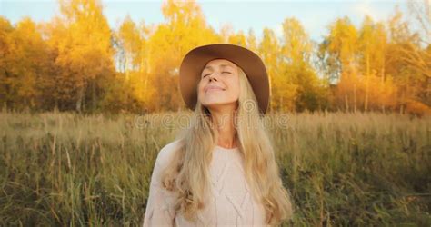 Happy Smiling Mature Woman Enjoying Warm Weather In Autumn Park With