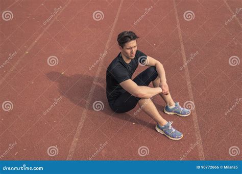 Elevated View One Young Man Resting Sitting Running Tracks Stock