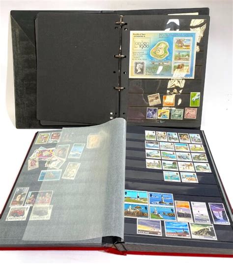 Two Stamp Albums including England, New Zealand, Cocos Islands...