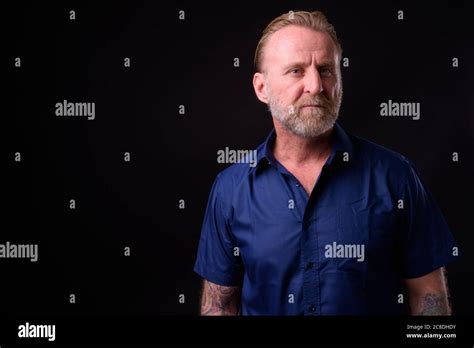 Mature Handsome Bearded Man With Blond Hair Against Black Background Stock Photo Alamy