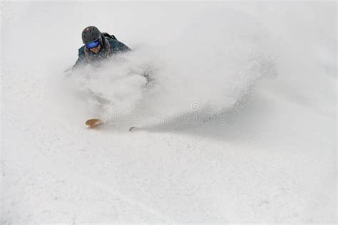 Close Up Of Active Skier Riding Down On Snow Covered Slope And Splash