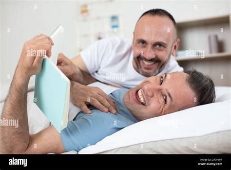 Happy Gay Couple Lying On Bed At Home Stock Photo Alamy