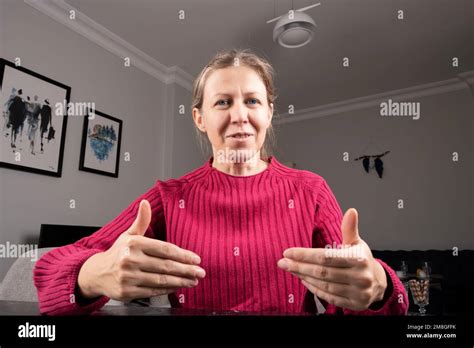 Caucasian Blue Eyes Blonde Woman Sitting On Webcam View Talking And Using Video Conference Call