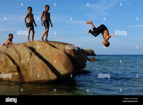 Local Malay kids jumping into the sea at Kijal beach in Kemaman, Terengganu Stock Photo - Alamy