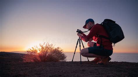 Photographer with Camera on Tripod at Sunset Stock Photo - Image of ...