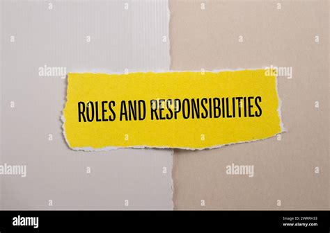 Roles And Responsibilities Words Written On Yellow Torn Paper