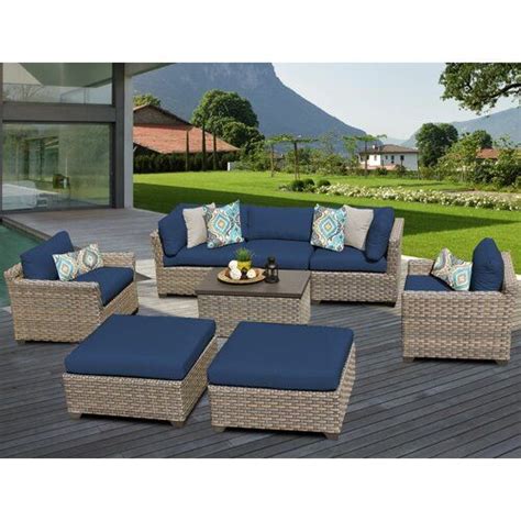 An Outdoor Patio Furniture Set With Blue Cushions