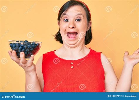 Brunette Woman With Down Syndrome Holding Blueberries Celebrating