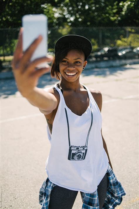 Woman Taking A Selfie In The Basketball Field By Stocksy Contributor