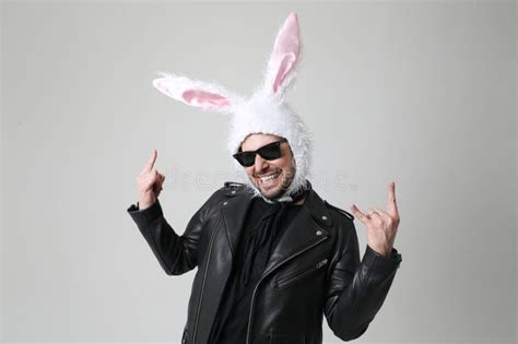 Emotional Bearded Man Wearing Bunny Ears And Sunglasses Posing Indoor