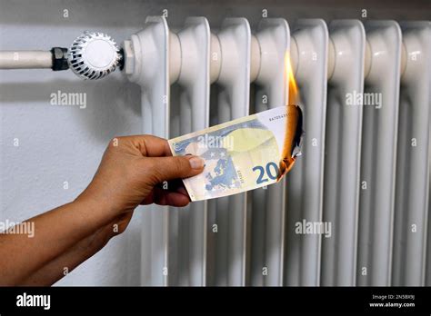 Hand With Burning 20 Euro Bill Price Increase Of Heating Stock Photo