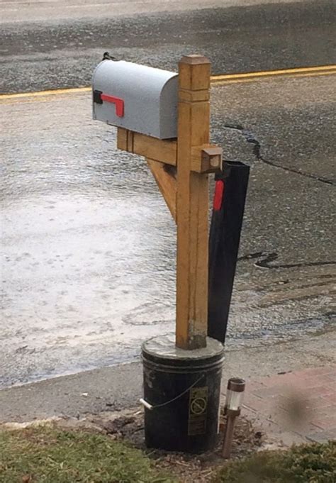 A Mailbox On The Side Of The Road In The Rain