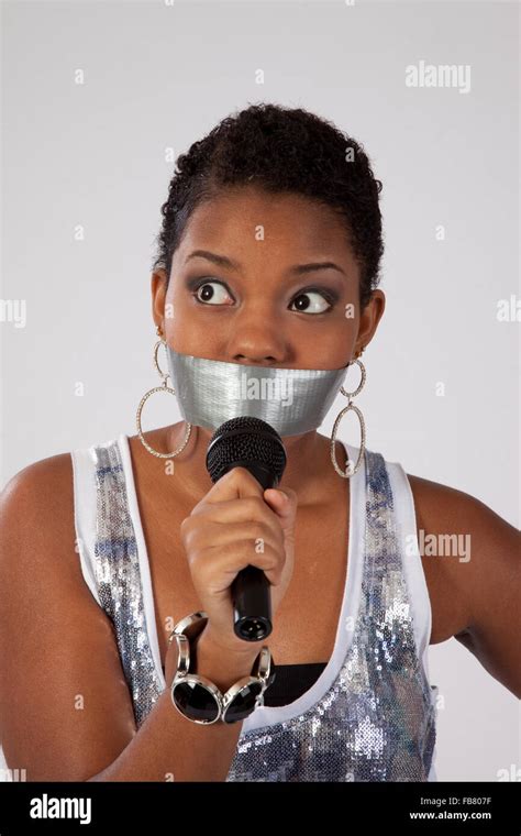 Pretty Black Woman With Duct Tape Over Her Mouth And Holding A