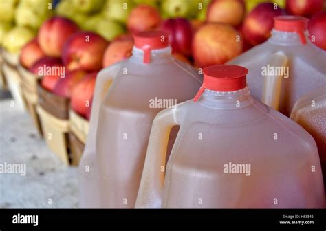 Apple Cider In Plastic Gallon Jugs With Apples At The Market Stock