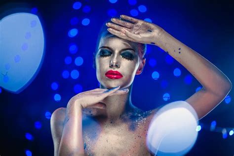 Premium Photo Naked Woman With Glitter Against Blue Background