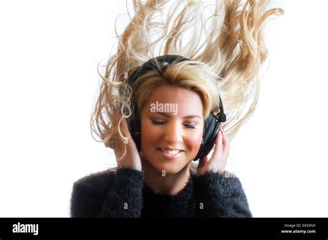 A Pretty Blonde Latina Girl Rocking Out And Flinging Her Hair While Listening To Large Black