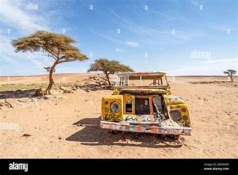 Yellow wrecked car car abandoned on Sahara desert in Morocco, Africa ...