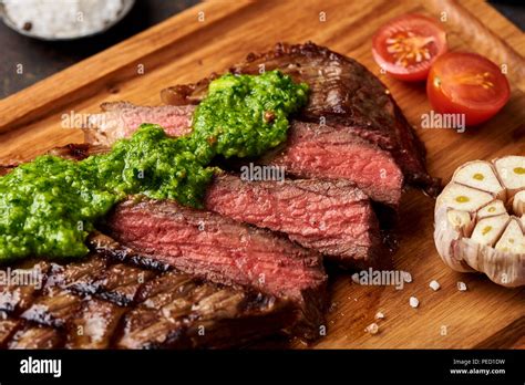 Grilled Black Angus Steak With Tomatoes Garlic With Chimichurri Sauce