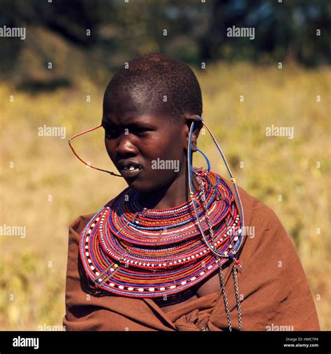 Maasai woman wearing necklaces with large pendants and beads ...