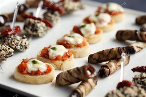 Small gourmet snacks on a plate — Stock Photo © yekophotostudio #25386925