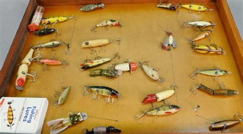 Twenty Seven Various Vintage Fishing Plugs In Display