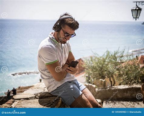 Handsome Man Listening To Music On Headphones Outdoor Stock Image Image Of Shorts Italy