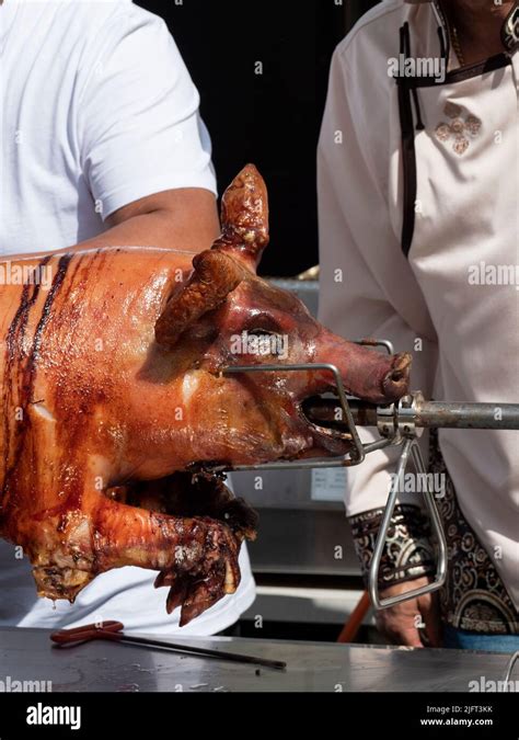 Vertical Photo Of A Grilled Suckling Pig On A Spit Stock Photo Alamy