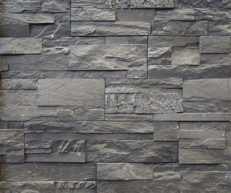 Stone Wall Cladding Made Of Gray Blocks And Bricks Of Natural Rocks