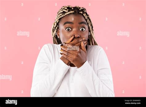 Surprised Young African American Woman Covering Her Mouth With Hands