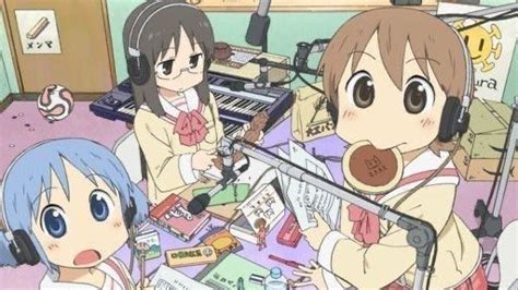 Two Anime Girls Sitting At A Table With Headphones And Microphones In