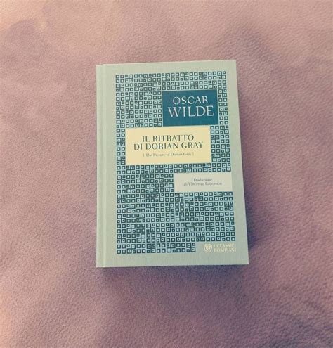 A Book Sitting On Top Of A Bed Next To A Pink Blanket And Pillow Cover