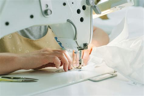 Person Sewing White Textile On White Sewing Machine · Free Stock Photo