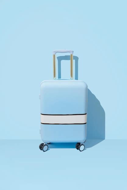 Premium Photo Suitcase On A Pastel Blue Background With Long Deep