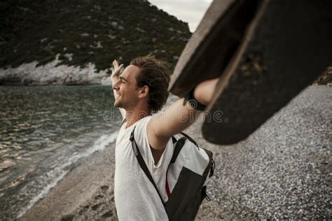 Caucasian Male Walking Along The Beach Standing With Arms Open